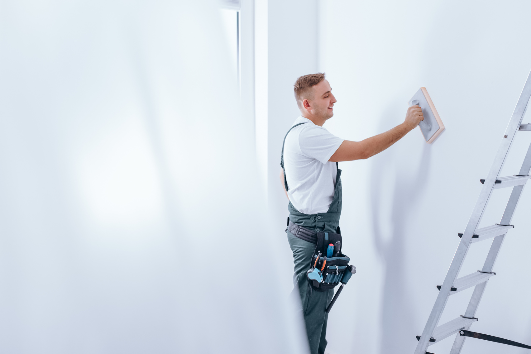 Painter smoothing the wall
